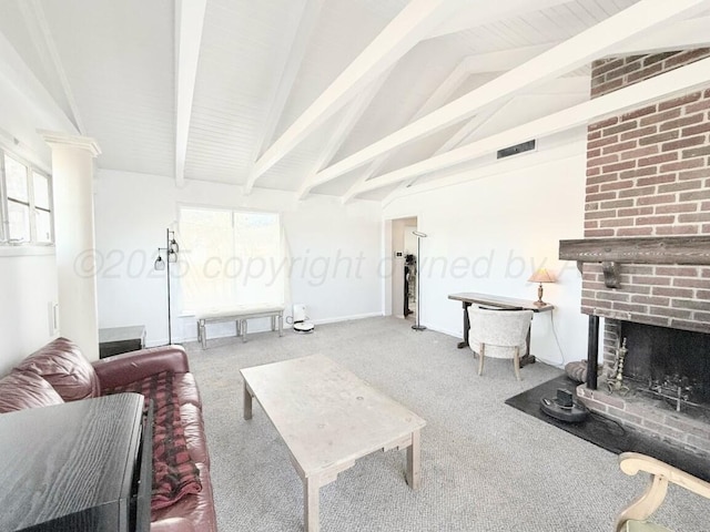 living room featuring lofted ceiling with beams, a brick fireplace, and plenty of natural light