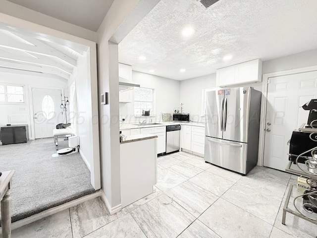 kitchen with white cabinetry, appliances with stainless steel finishes, sink, and a textured ceiling