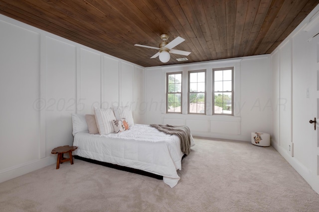 bedroom featuring light carpet, ceiling fan, and wood ceiling