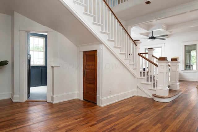 stairs featuring coffered ceiling, hardwood / wood-style flooring, ceiling fan, ornamental molding, and beamed ceiling