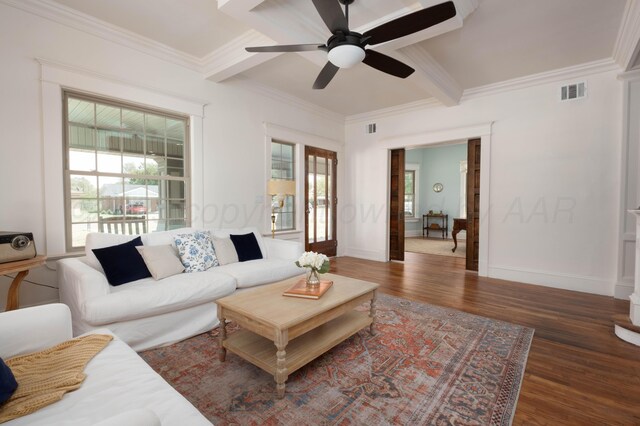 living room featuring ceiling fan, beam ceiling, dark hardwood / wood-style flooring, and ornamental molding