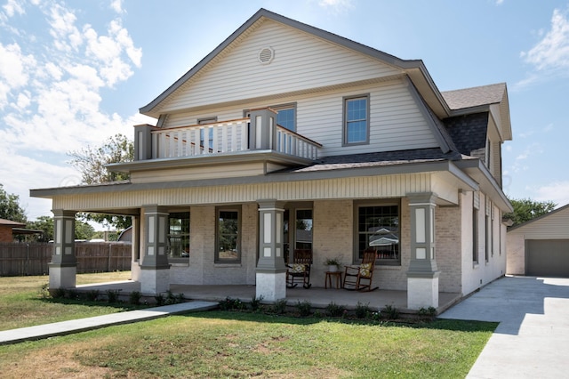 view of front of property featuring a balcony, a front lawn, and a porch