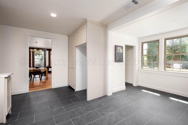 interior space with an inviting chandelier and plenty of natural light