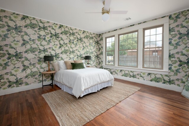 bedroom with ceiling fan and dark hardwood / wood-style floors