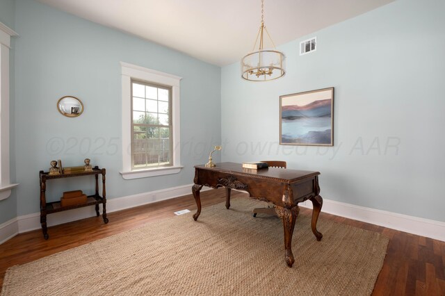 office space with a chandelier and wood-type flooring