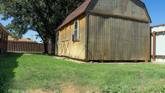 view of outbuilding with a lawn