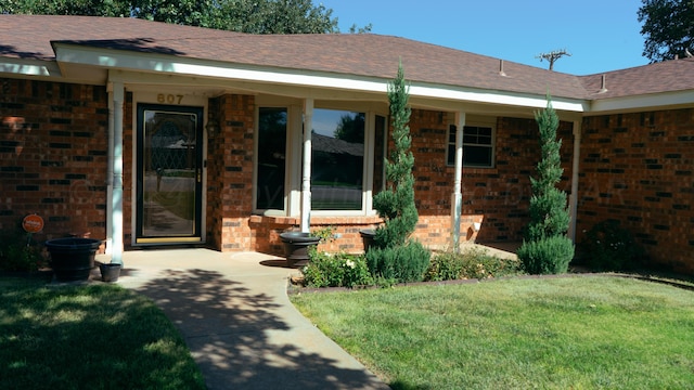 doorway to property featuring a yard