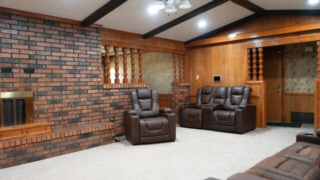 cinema with carpet, vaulted ceiling with beams, and wooden walls