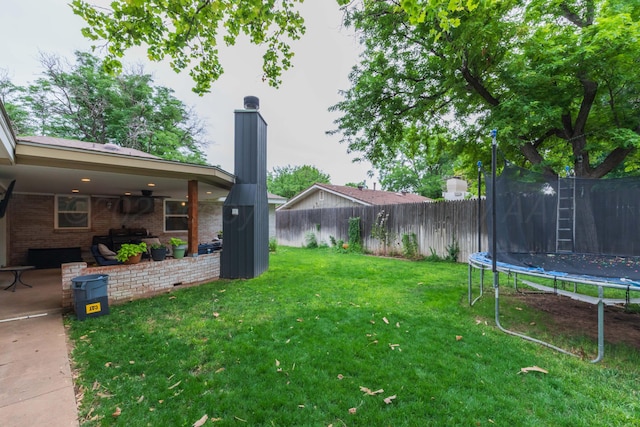 5109 Tawney Ave, Amarillo, TX 79106 - fenced backyard with a trampoline and a patio