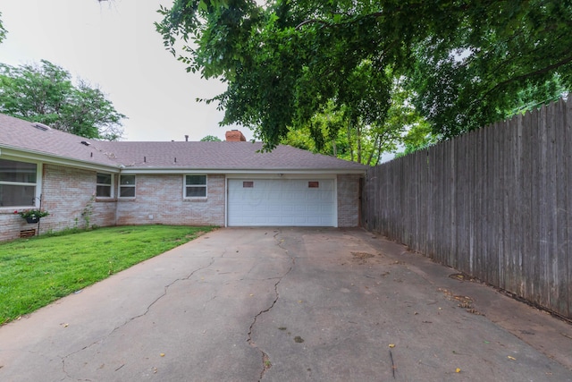 5109 Tawney Ave, Amarillo, TX 79106 - view of side of home with brick siding, an attached garage, a chimney, and driveway