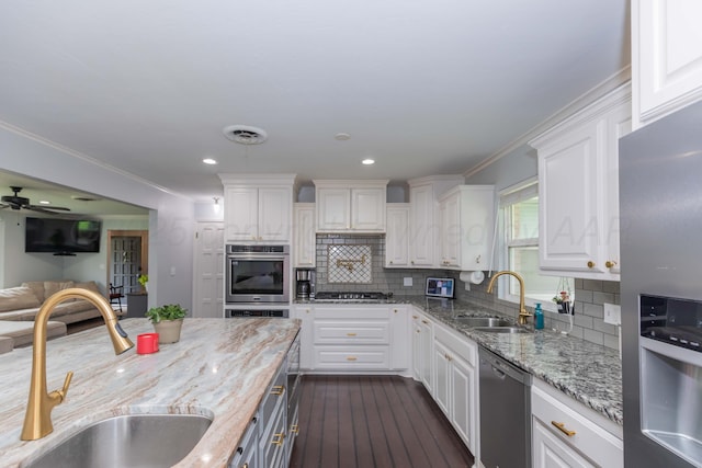 5109 Tawney Ave, Amarillo, TX 79106 - kitchen featuring stainless steel appliances, white cabinets, light stone counters, dark wood-style flooring, and backsplash