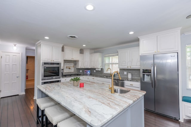 5109 Tawney Ave, Amarillo, TX 79106 - kitchen featuring stainless steel appliances, white cabinetry, decorative backsplash, ornamental molding, and recessed lighting