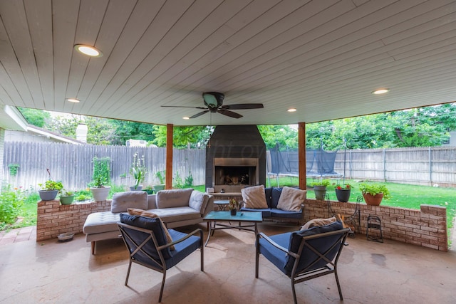 5109 Tawney Ave, Amarillo, TX 79106 - fenced backyard with a patio, an outdoor living space with a fireplace, and a trampoline