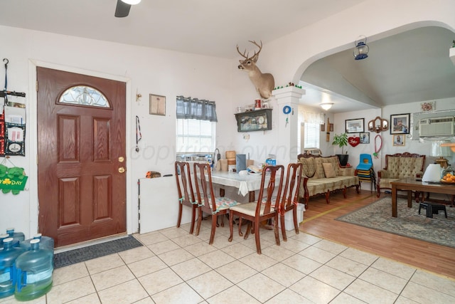 1411 N Highland St, Amarillo, TX 79107 - dining room featuring arched walkways, ceiling fan, light wood finished floors, a wall mounted air conditioner, and vaulted ceiling