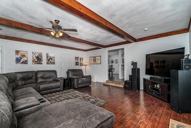 living room with ceiling fan, beam ceiling, dark hardwood / wood-style flooring, and a textured ceiling