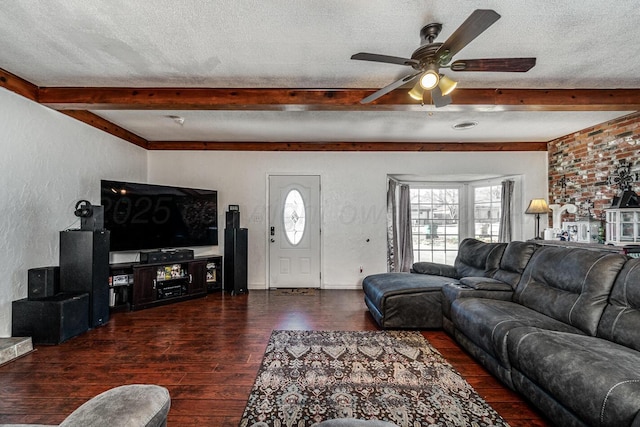 living room featuring a textured ceiling, dark wood-type flooring, and ceiling fan