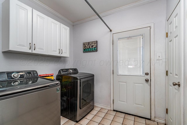 laundry room featuring cabinets, light tile patterned floors, crown molding, and washing machine and dryer