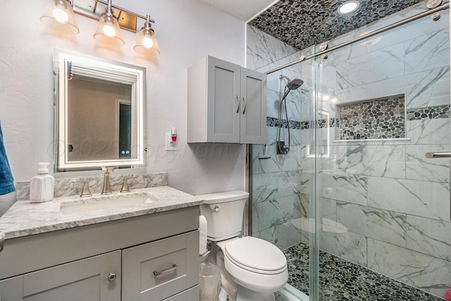 bathroom featuring an enclosed shower, vanity, and toilet