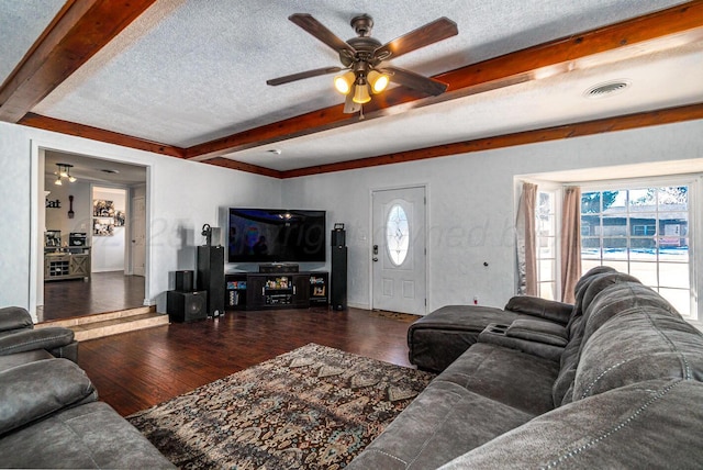 living room featuring a textured ceiling, ceiling fan, and dark hardwood / wood-style flooring