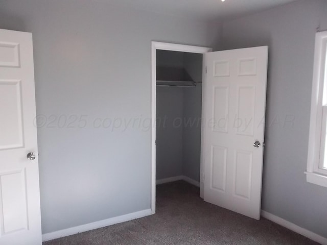 805 Brevard St, Hereford, TX 79045 - unfurnished bedroom featuring dark carpet and a closet