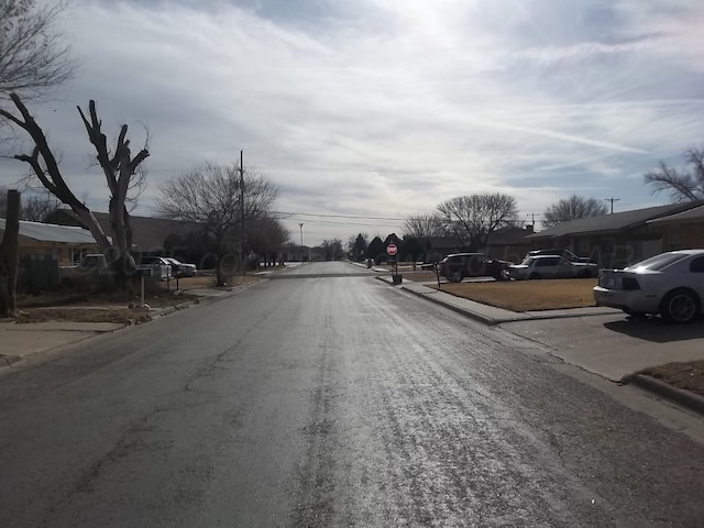 805 Brevard St, Hereford, TX 79045 - view of asphalt road with traffic signs, curbs, and a residential view