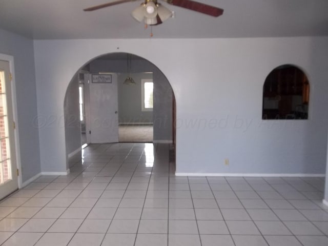 805 Brevard St, Hereford, TX 79045 - spare room with arched walkways, ceiling fan, and light tile patterned floors