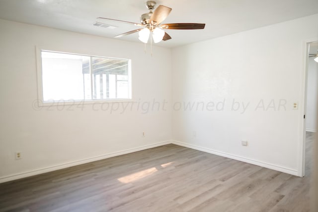 spare room with ceiling fan and wood-type flooring