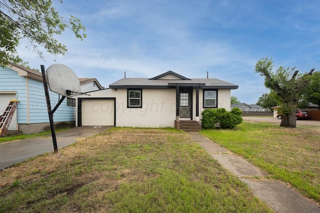 301 Estireno St, Borger, TX 79007 - bungalow with concrete driveway, a garage, stucco siding, and a front yard