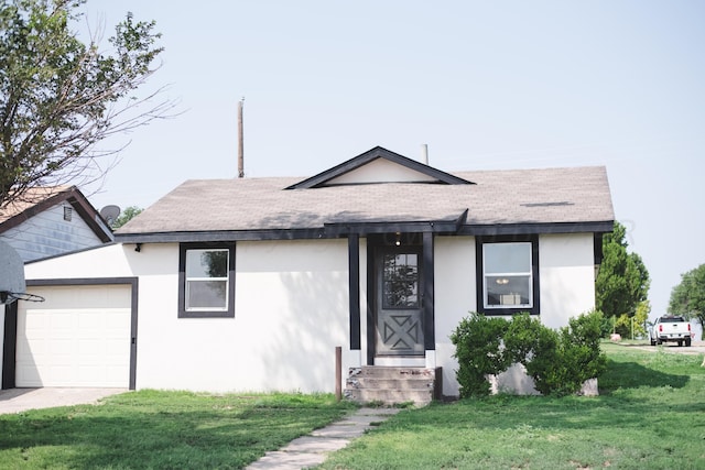 ranch-style home with a front yard and a garage