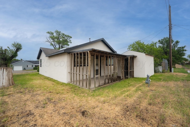 301 Estireno St, Borger, TX 79007 - rear view of house with a yard and stucco siding