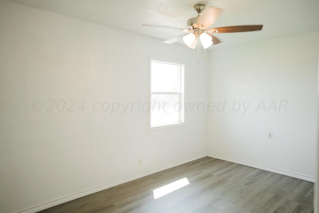 unfurnished room featuring ceiling fan and hardwood / wood-style flooring