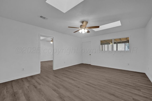 301 Estireno St, Borger, TX 79007 - unfurnished room featuring visible vents, dark wood-style flooring, a skylight, and ceiling fan