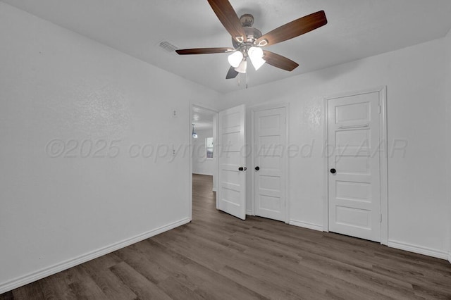 301 Estireno St, Borger, TX 79007 - unfurnished bedroom featuring wood finished floors, baseboards, and ceiling fan