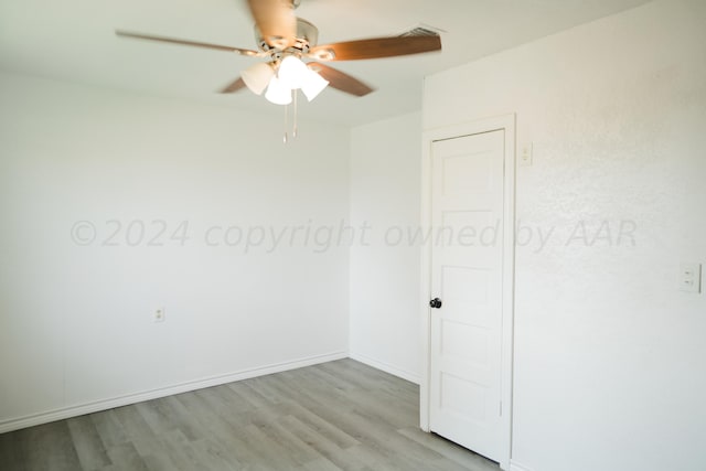 empty room featuring ceiling fan and light wood-type flooring