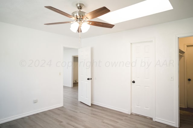 unfurnished bedroom with a closet, light hardwood / wood-style floors, and ceiling fan