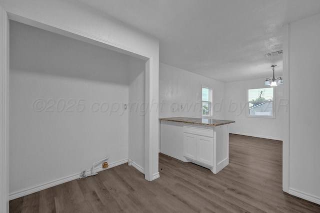 301 Estireno St, Borger, TX 79007 - kitchen featuring stone countertops, dark wood finished floors, white cabinetry, visible vents, and baseboards
