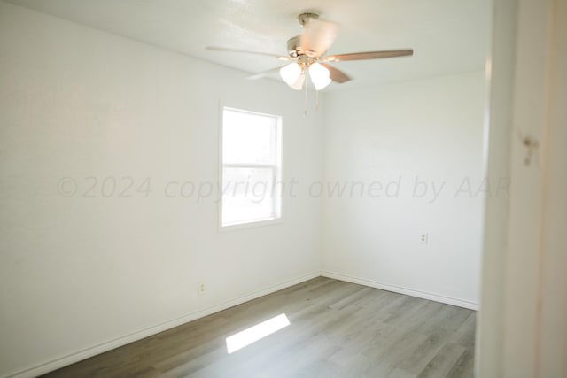 empty room featuring light wood-type flooring and ceiling fan