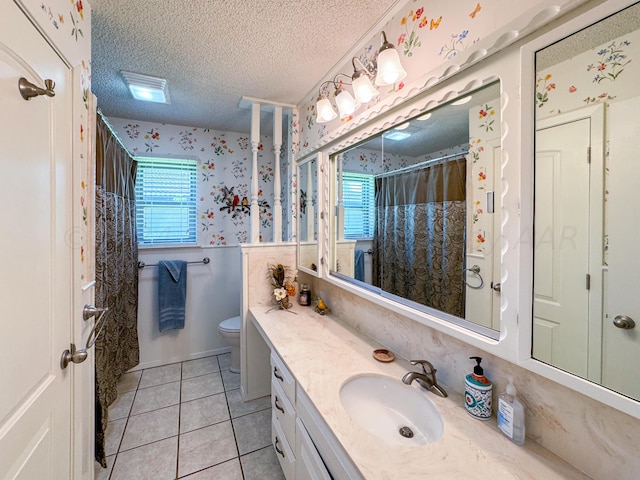 bathroom featuring tile patterned flooring, a shower with curtain, a textured ceiling, vanity, and toilet