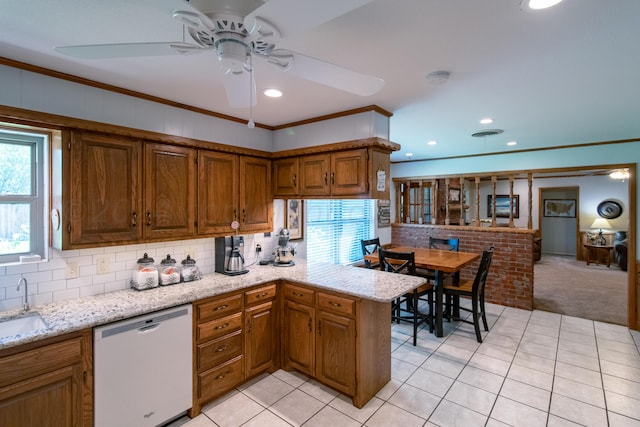 kitchen featuring dishwasher, light carpet, a healthy amount of sunlight, and crown molding