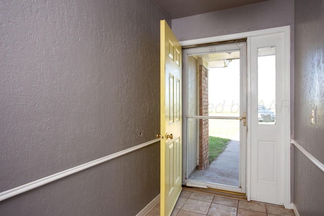 505 Alamo St, Claude, TX 79019 - doorway with a textured wall and tile patterned floors
