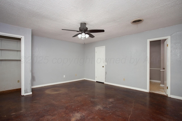 505 Alamo St, Claude, TX 79019 - unfurnished bedroom featuring finished concrete floors, baseboards, a textured ceiling, and a ceiling fan