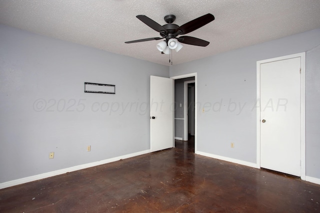 505 Alamo St, Claude, TX 79019 - unfurnished bedroom featuring finished concrete floors, baseboards, a textured ceiling, and a ceiling fan