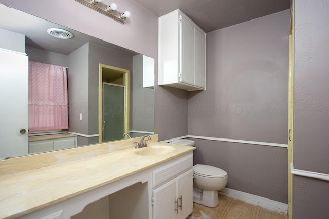 505 Alamo St, Claude, TX 79019 - bathroom featuring a shower stall, toilet, vanity, baseboards, and tile patterned floors