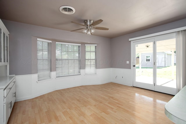 505 Alamo St, Claude, TX 79019 - unfurnished room featuring a wainscoted wall, light wood-style flooring, and a ceiling fan