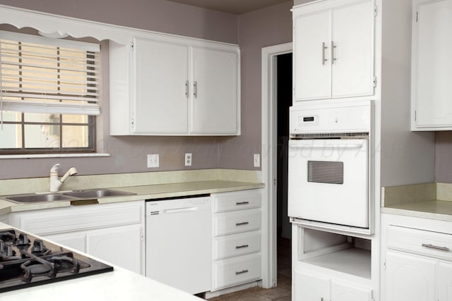 505 Alamo St, Claude, TX 79019 - kitchen with white appliances, a sink, white cabinetry, and light countertops