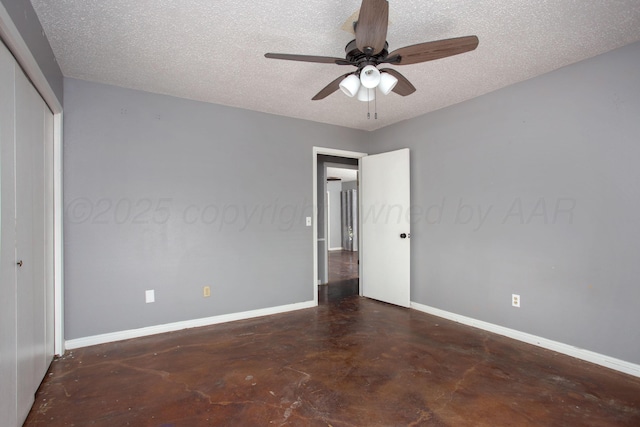 505 Alamo St, Claude, TX 79019 - unfurnished bedroom featuring finished concrete floors, baseboards, a textured ceiling, a closet, and ceiling fan