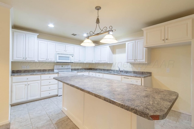 kitchen featuring white cabinetry, a kitchen island, and white appliances