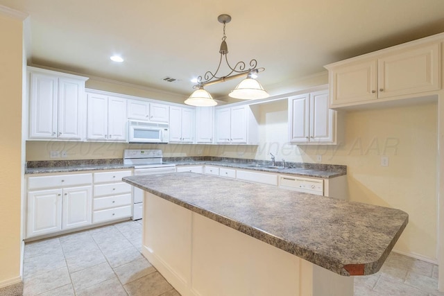 3520 S Mirror St, Amarillo, TX 79118 - kitchen with white appliances, a kitchen island, white cabinets, hanging light fixtures, and dark countertops