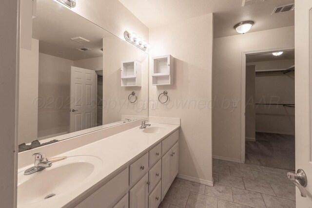 3520 S Mirror St, Amarillo, TX 79118 - bathroom featuring double vanity, a spacious closet, and tile patterned floors