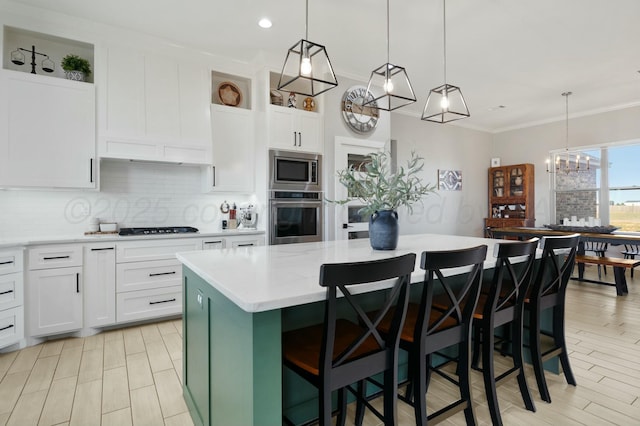 3851 Whitetail Springs Rd, Amarillo, TX 79119 - kitchen with a center island, ornamental molding, white cabinetry, stainless steel appliances, and decorative backsplash